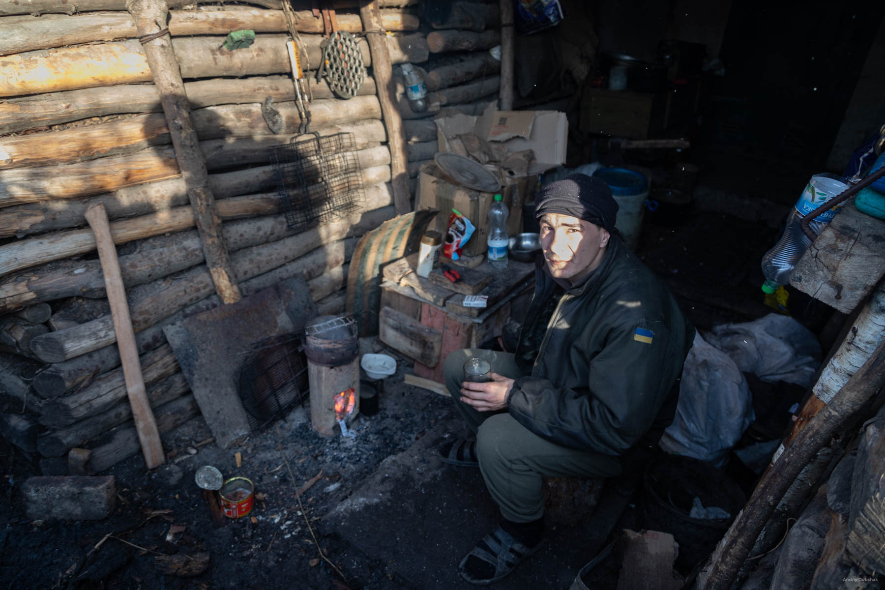 A fighter is drinking tea in the dugout-observer, near Popasnaya, December 2017.
