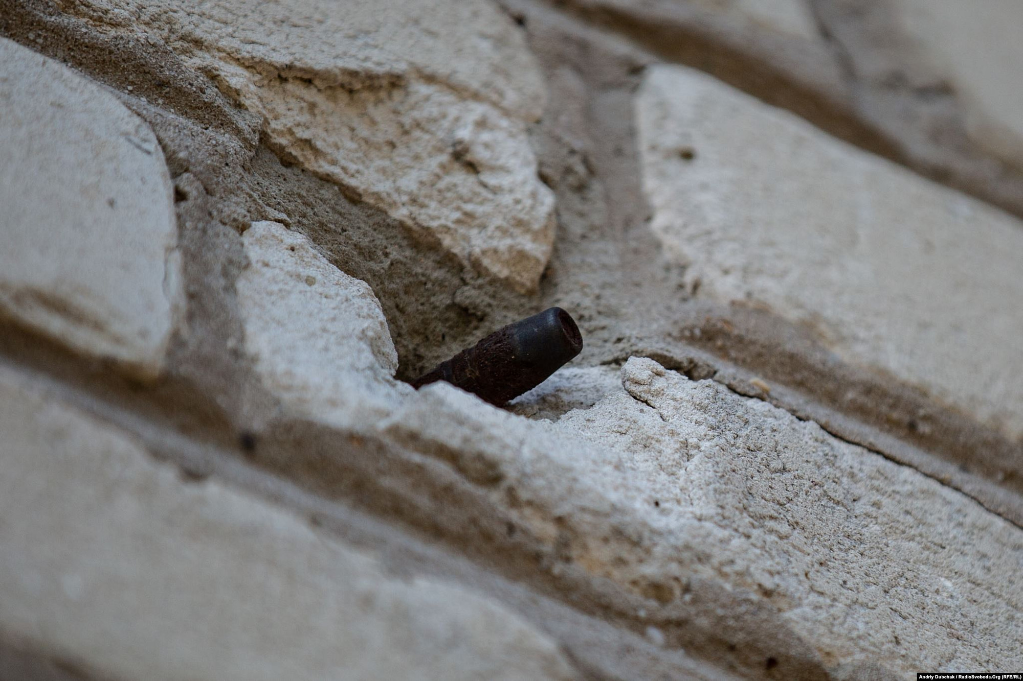 A bullet from a large-caliber machine gun is lodged in the wall of Toma's house. (photo: Andriy Dubchak)