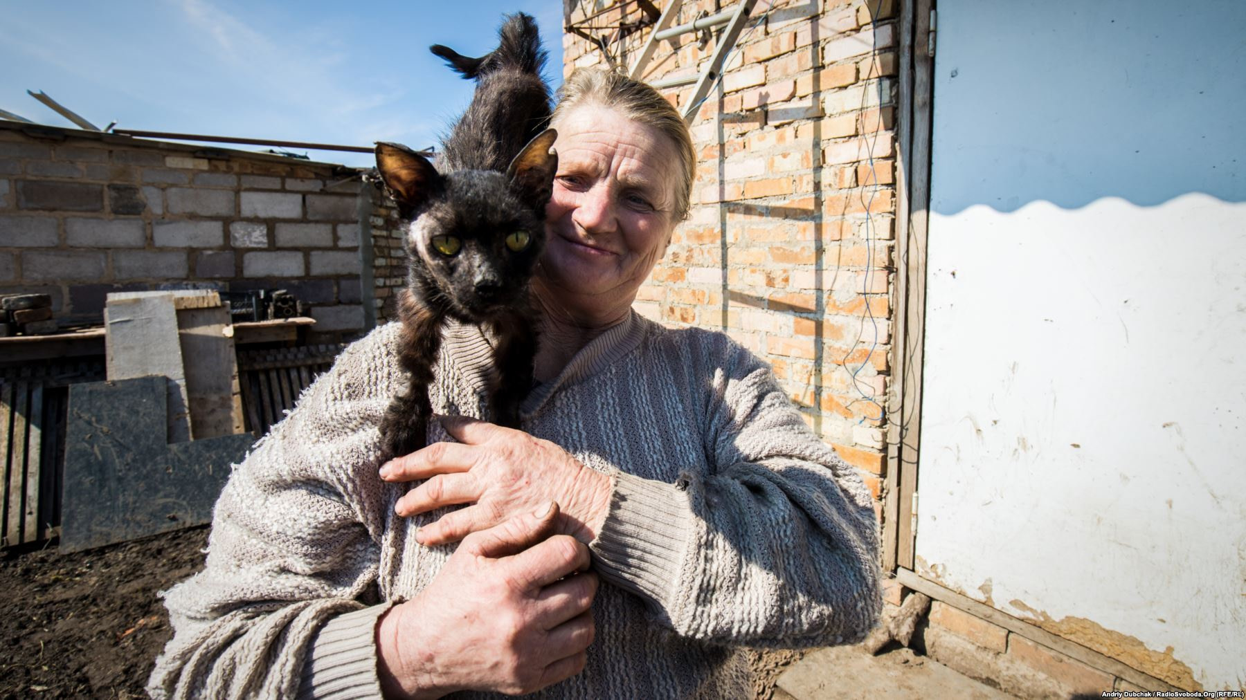 Kral with her cat, Timka. The cat was discovered badly wounded "with blood covering half of its face" after a recent battle, and Kral is now nursing him back to health. Photo by: Andriy Dubchak