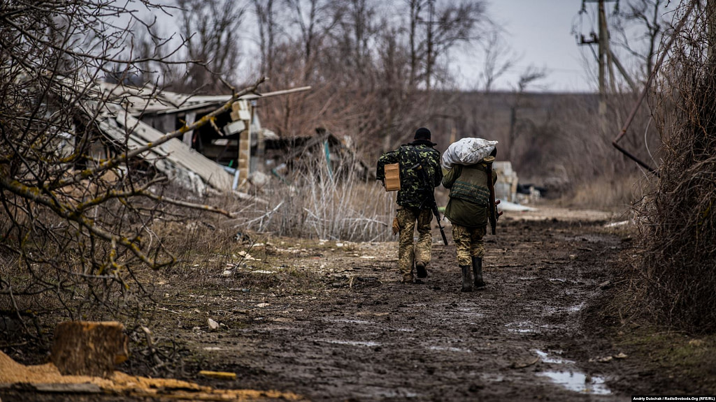 Ukrainian marines carry potatoes and other food toward a frontline position. Photo by Andriy Dubchak