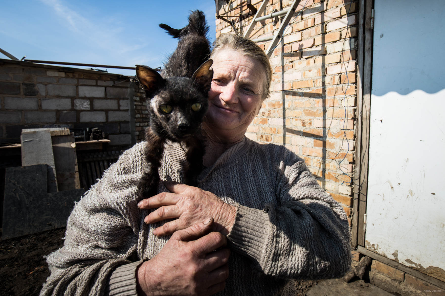 "Hello from Vodyane". Baba Zoe with her cat Timka. The cat was wounded and ill, the woman nursed it, as she could. Vodyane, March 2018.