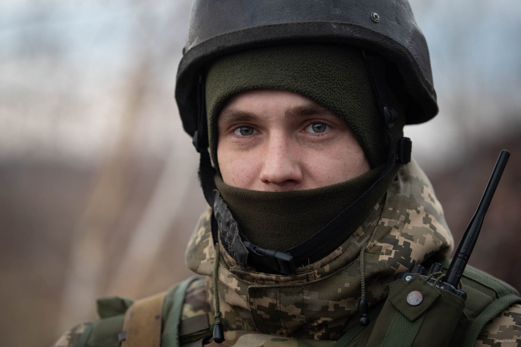 Alexander is 28 years old. Originally, from Chernigov region, he speaks calmly, confidently, logically. He is in the war since 2014, started fighting with the first wave of mobilization. Three months later, he was discharged for some reason. In 2015, he was called up for military service again with the sixth wave of mobilization. He served 15 months mobilization duty, and then remained for a half-year contract.  After that he returned home for six months, could not stand it and signed the contract. In a matter of a split second after this photo shot, we were shot at by an enemy sniper.  (Video of this moment: https://goo.gl/pBeMHU) It was a narrow escape, but a week later, a sniper tapped the boy in the head. 7.62 bullet came under the helmet - the brain was injured. Now, he is slowly recovers and undergoes a long rehab in Lviv. District of Popasnoy, December 2017